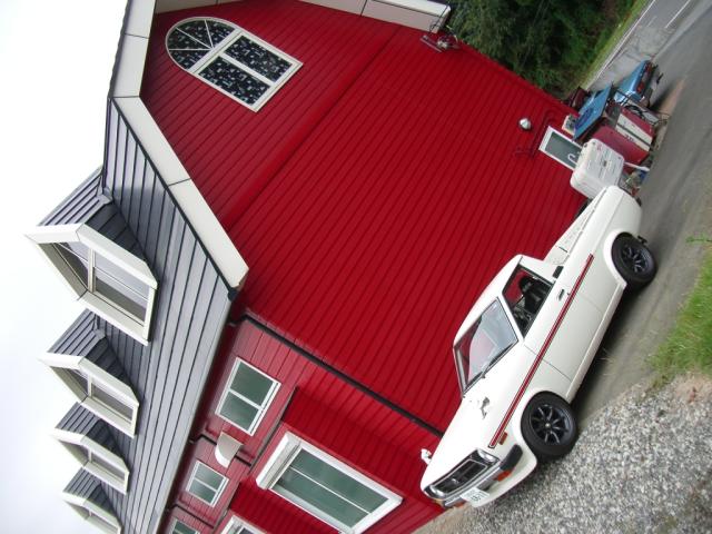 Toyota Corolla KE30 pickup in front of a European looking house