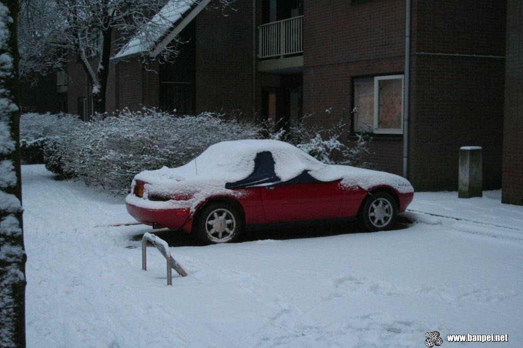 Red Mazda Miata covered in snow!