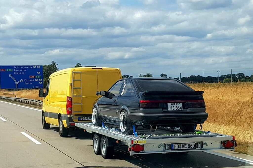 JDM AE86 Trueno being towed on a trailer with German vanity license plate FD-AE-860