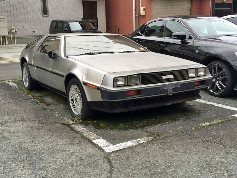 Neglected DeLorean DMC12 in a Japanese parking lot