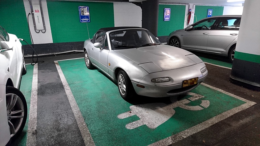 The first time I spotted this Mazda Miata NA hogging an EV charging spot